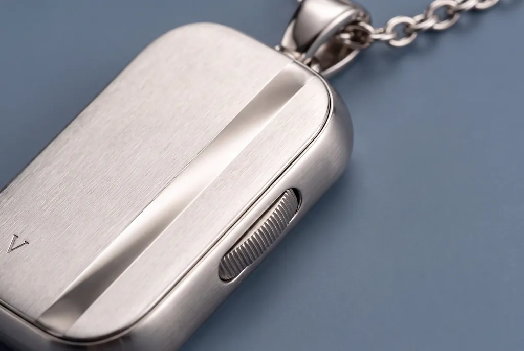 Close-up of the Vault capsule's brushed silver face and its side dial.